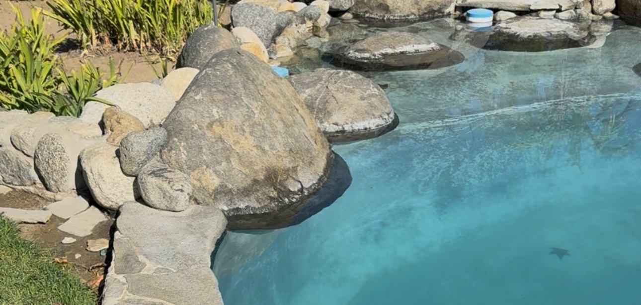 Natural stones in pool wall